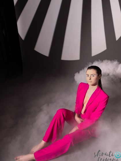 A full-body shot using smoke and graphic light projections to create a modern, high-fashion aesthetic. This shows how we can combine different techniques for a truly custom look.