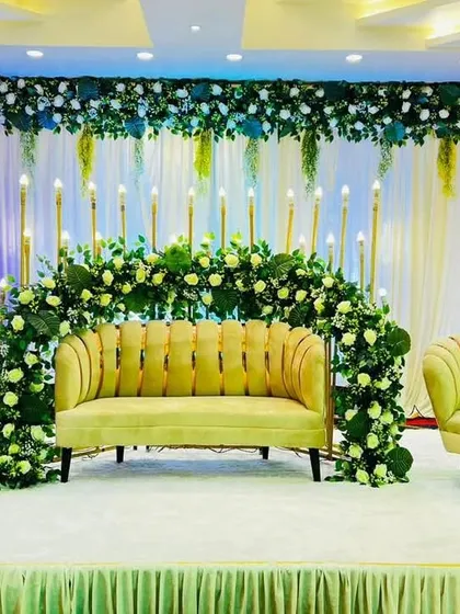 Another one of our green-themed stage decorations at Grand Utsav Banquet. The half-arch of white and yellow flowers against a lush green backdrop provides a natural yet elegant setting for any event.