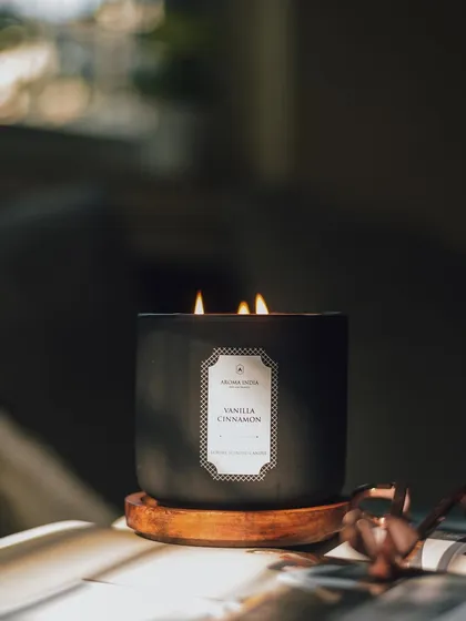 Minimalism never goes out of style. Our signature three-wick candle in Vanilla Cinnamon, housed in a matte black jar with a wooden base, adds a touch of warmth and sophistication to any personal space.