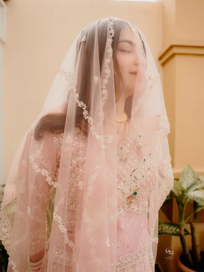 A soft and delicate portrait of the bride under her veil. The focus on her serene expression captures the inner peace and joy of her Nikah day.