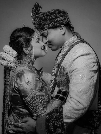 A classic and intimate black and white portrait of the bride and groom, capturing a quiet moment of connection on their wedding day.