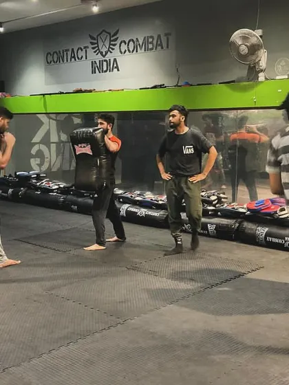 Students of all levels train together, learning from each other. Here, a mixed group practices their striking on pads and shields.