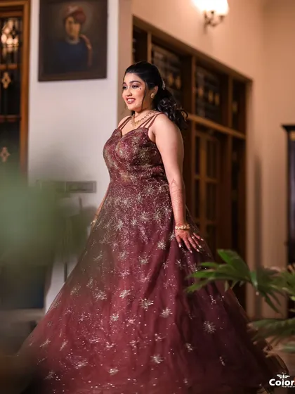 A lovely solo portrait of the bride in her sparkling reception gown, captured in a candid, in-between moment.