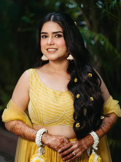A beautiful portrait of our Haldi bride. Her skin is glowing, and her makeup is kept minimal to complement the bright yellow of her outfit.