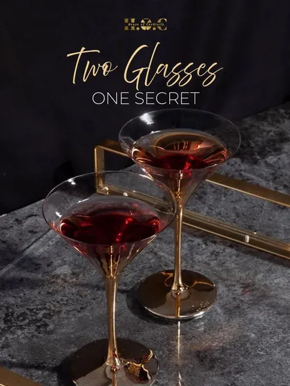 An intimate moment with one of our creations. The elegant glassware and rich color of the cocktail hint at the secret to our service: quality ingredients and masterful crafting.
