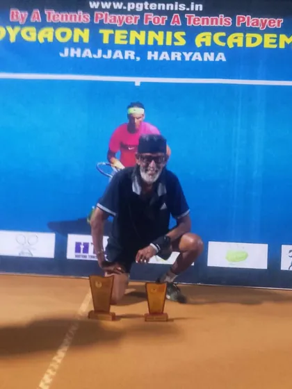 A senior player with his two trophies. His dedication is an inspiration to all of us.