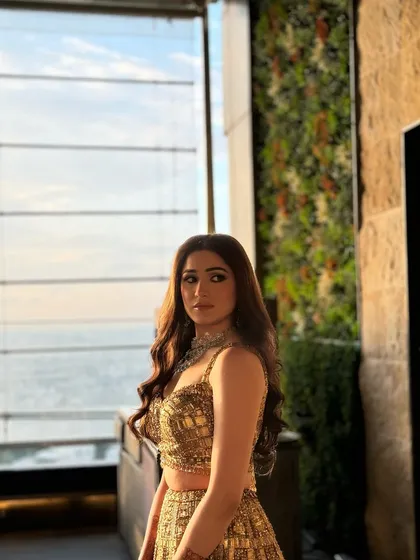 The client looks stunning against the city skyline, her wavy hair catching the golden hour light beautifully.