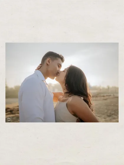 A romantic kiss backlit by the setting sun. This style of silhouette and flare is perfect for creating dramatic and emotional pre-wedding photographs.