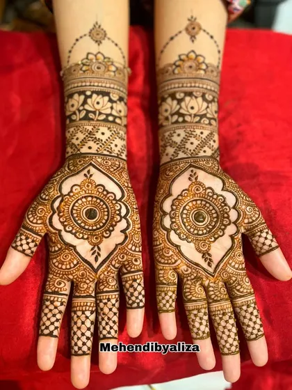 A designer creation featuring a central mandala on the palm, surrounded by intricate checks and floral bands on the wrist and fingers.