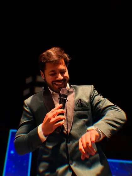 Checking the time? More like checking if the energy level is high enough! A fun moment captured mid-hosting at a Sangeet.