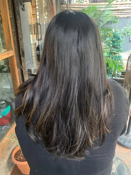 A before shot showing the client's previous color, setting the stage for the 'Date Pudding' transformation.
