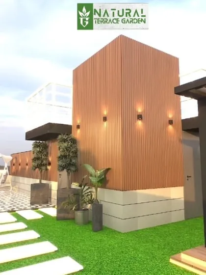 A proposed terrace design featuring multiple structures, including a wooden-clad cube and a pergola, connected by a lawn and pathway.