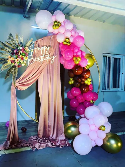 This is a duplicate of ID 142, 167, 212. A beautiful circular backdrop with pink drapes and a vibrant balloon arrangement. This setup combines soft fabrics with bright balloons for a sophisticated and celebratory look.