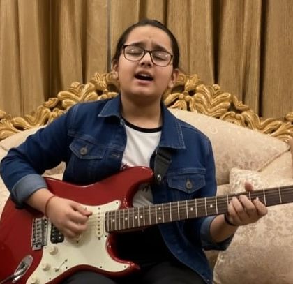 Meet our shining star, Alish Mishra, a talented musician who reached the semi-finals of a national singing competition. Here she is, passionately playing her guitar.