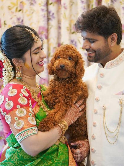 A heartwarming photo of the couple with their beloved pet poodle, making it a complete family picture during the traditional ceremony.