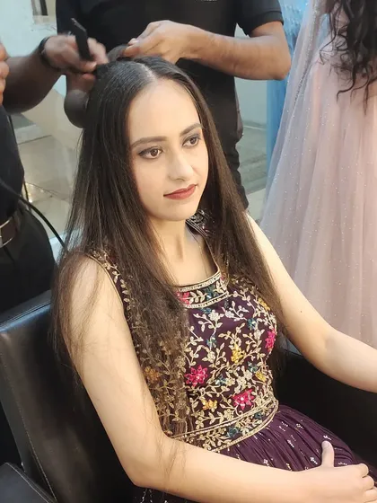 Getting the hair just right is key. Here, I am adding texture and volume by crimping the roots before styling, a technique I use to ensure party hairstyles have body and hold their shape all evening.
