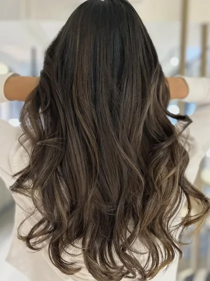 A cool-tone balayage blend that provides a major refresh. The three-tone color and long layers haircut result in a modern and sophisticated look.