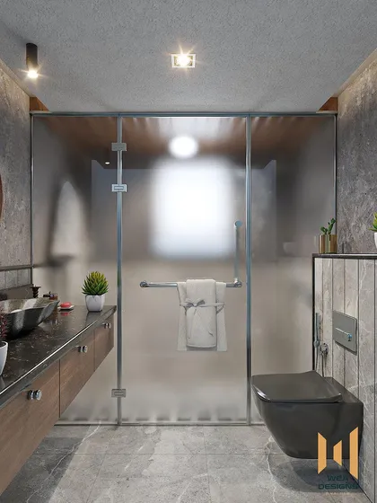 A bathroom with a grey monochrome design, featuring a floating wooden vanity and a frosted glass shower partition.