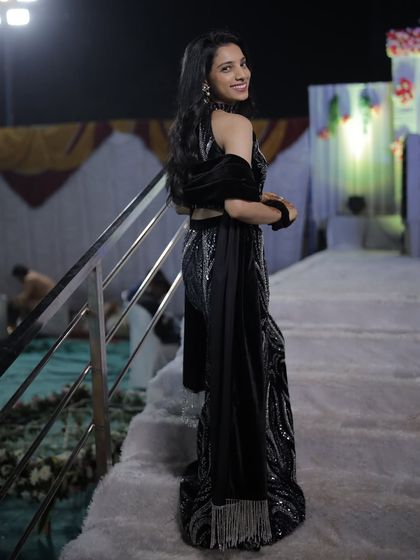 A back view of the glamorous black fish-cut skirt and top, showing how the sequined fabric catches the light. This silhouette is designed to be flattering and is perfect for a Sangeet or reception party.
