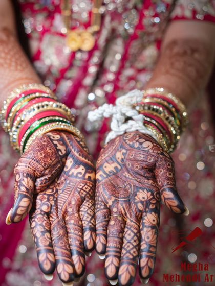 The deep, rich color of the bridal mehendi is stunning against the bride's red attire and bangles. This photo shows the beautiful stain my henna can achieve.