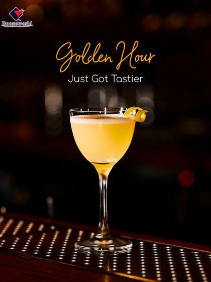 A classic sour-style cocktail with a frothy top and a lemon twist, served in a coupe. This drink balances tart and sweet for a perfectly tasty golden hour experience.