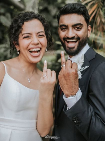 "We did it!" A fun shot of the couple showing off their wedding rings.