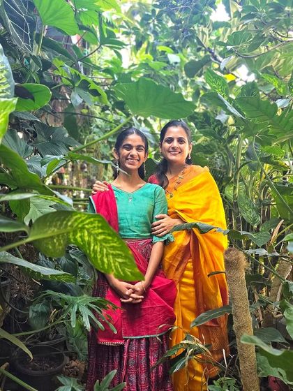 My wife and daughter standing amidst the lush foliage. They are my biggest supporters and partners in this green journey.