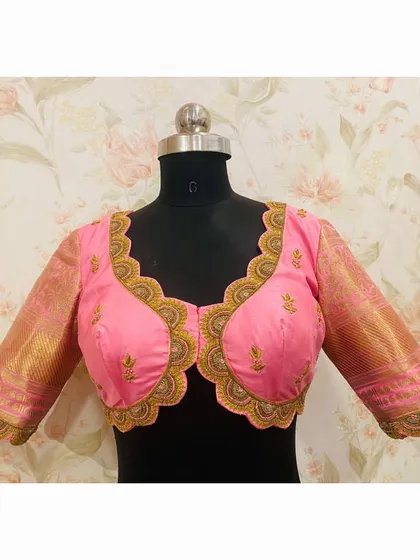 The front view of the pink blouse with a scalloped neckline, showing the delicate embroidery and the beautiful fit.