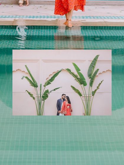 A creative reflection shot of a couple standing by a pool, their image mirrored in the water.