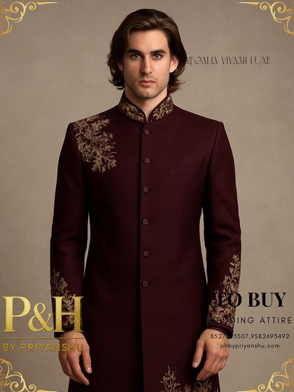A portrait shot emphasizing the regal collar and shoulder embroidery of the wine Indo-Western suit, designed to frame the face and command attention.