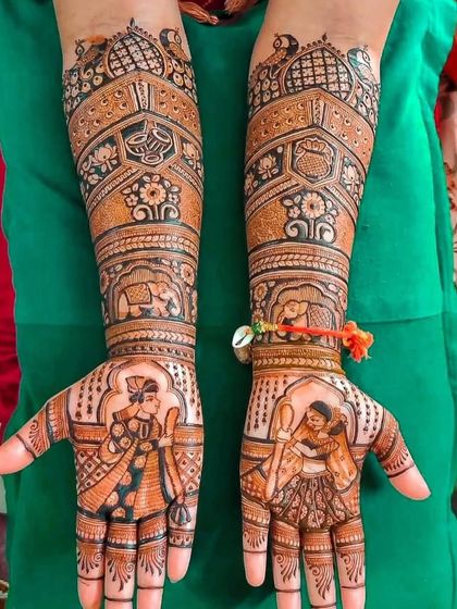 This design combines a couple portrait with traditional motifs like the kalash and elephants.