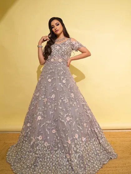 A fairytale moment in a lilac gown. This look is perfect for a sangeet or reception, with soft hues of pink and purple in the makeup to match the floral embroidery of the dress.