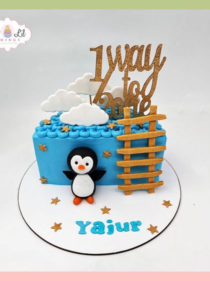 A sweet penguin-themed cake celebrating Yajur's journey "1 way to one," featuring a ladder to the sky.