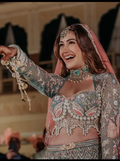 Another look at the happy bride in our exclusive designer pastel lehenga. Renting a couture piece like this makes your dream wedding look attainable.