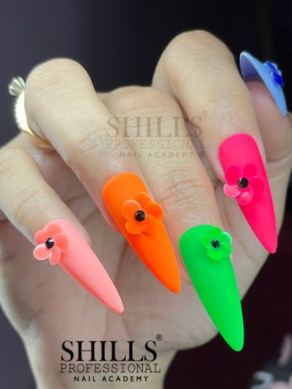 A full hand view of the neon nails with 3D flowers, showing how the different colors work together for a vibrant look.