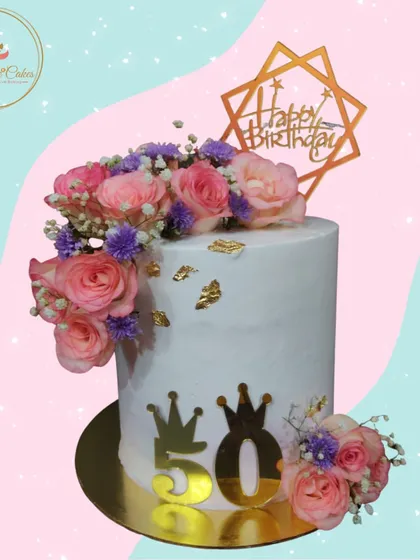 A 50th birthday deserves nothing less than elegance. I designed this tall cake with a cascade of fresh pink and purple roses, accented with delicate baby's breath and edible gold leaf, creating a sophisticated centerpiece for a landmark celebration.