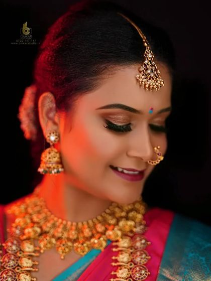A soft and serene bridal portrait captured in our studio. We used a gentle light to illuminate her features, focusing on the delicate details of her makeup and the beautiful craftsmanship of her traditional gold jhumkas and necklace.