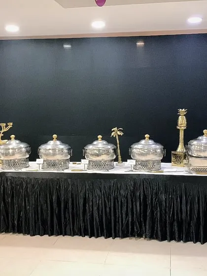 Another angle of the corporate catering setup for 150 guests at Encedo Inc. The long buffet line is elegantly arranged against a dark, modern backdrop.