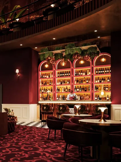 A wider view of the bar, showing the relationship between the bar counter and the surrounding seating areas.