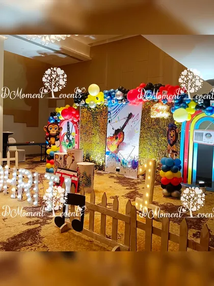 A side view of the musical-themed stage, showing the white picket fence and the arrangement of props like a vinyl record and musical notes.
