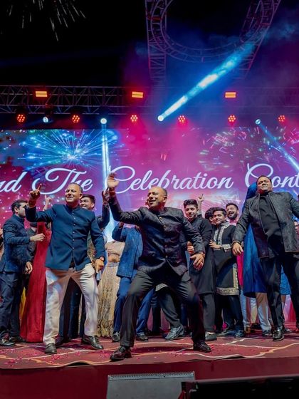 And the celebration continues. A candid shot of the groom's father and friends taking over the stage, showing that the party doesn't stop when the choreographed numbers end.