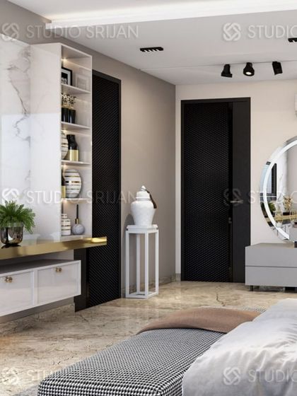 This angle shows the functional layout, with a TV unit, storage shelves, and a separate vanity table with a large, round, backlit mirror.