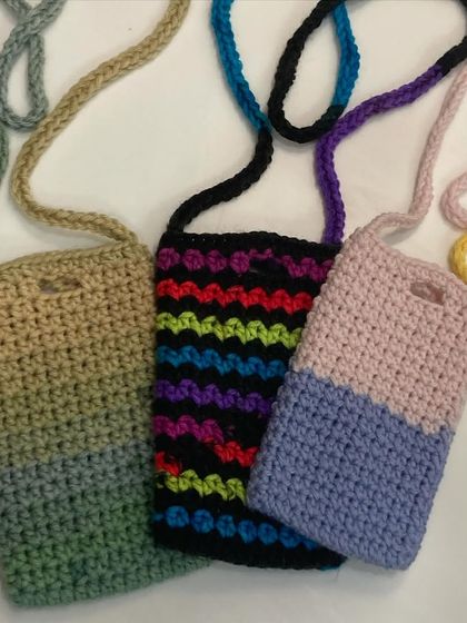 A closer look at some of the different phone sling designs I offer. You can see a two-tone pink and purple, a rainbow stripe, and a gradient green and beige one here.
