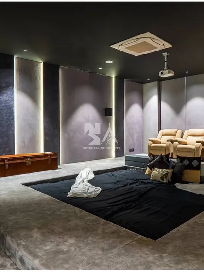 For this home theater, we created a unique dug-out lounge area for casual, comfortable viewing, supplemented by plush recliners. The design includes a cleverly concealed bar, ensuring that cinematic experiences are always paired with a touch of functional luxury.