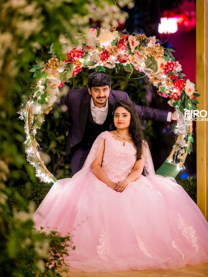 A playful pose on the floral swing, showcasing how the lighting creates a magical backdrop for any couple's photoshoot.