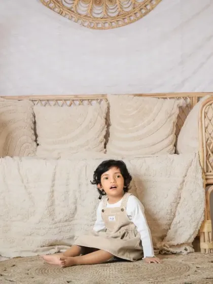 A full view of our versatile boho setup, featuring pampas grass, a wicker sofa, and neutral-toned decor.