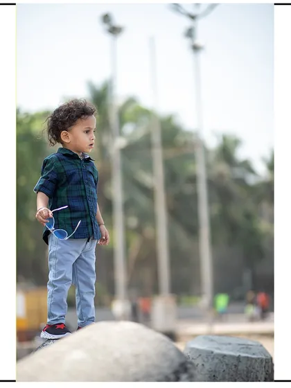 A vertical composition from the beach photoshoot, capturing a quiet moment of observation.