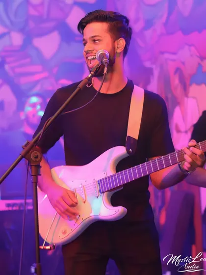 A great action shot of our guitarist Joshua, smiling while he plays. This photo perfectly captures the fun and rock and roll spirit of our live shows.