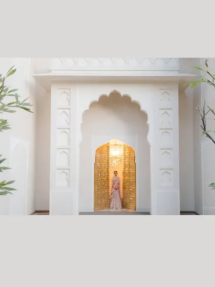 The architecture of a space is part of the story. Here, I framed the bride within a series of arches, using the clean white lines and the pop of the golden door to create a minimalist yet majestic bridal portrait.