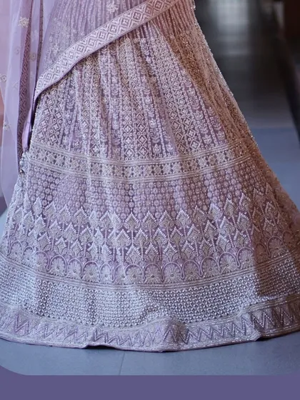 A closer look at the artistry. This pastel lehenga is covered in delicate, intricate embroidery, showcasing the hours of handwork that go into creating such a graceful and detailed piece.